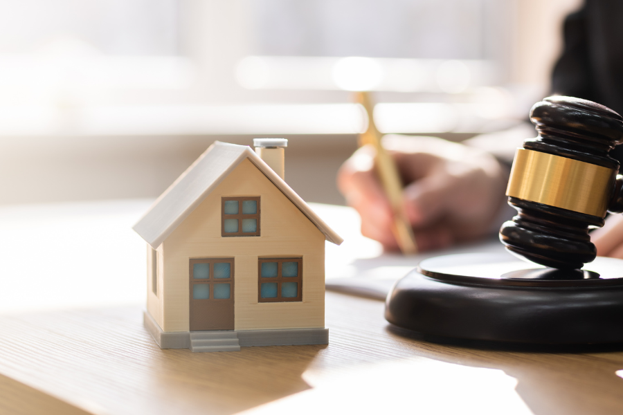 buying a home before divorce, judge gavel and miniture home